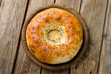 Uzbek bread from tandoor on old wooden table top view