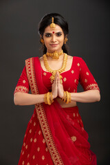 Fototapeta premium Pretty Indian young Hindu Bride against grey background.