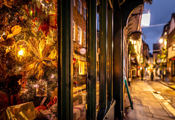 A Chirstmas night view of Shambles, a historic street in York featuring preserved medieval timber-framed buildings with jettied floors