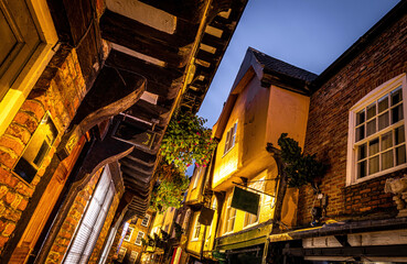 A Chirstmas night view of Shambles, a historic street in York featuring preserved medieval...
