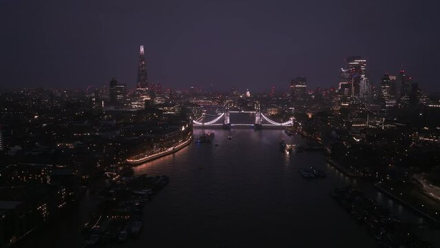 Aerial view to the illuminated Tower Bridge and skyline of London, UK at night. Beautiful center of London. 