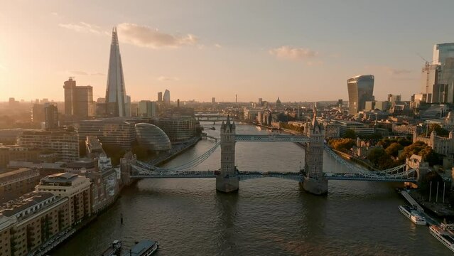 Iconic Tower Bridge at sunset. Connecting London with Southwark on the Thames River. Aerial sunset view of London city center and the Tower bridge of London. 