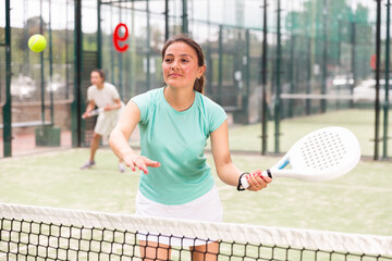 Two sports couples playing padel on the tennis court