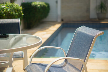 table and chairs on the pool area