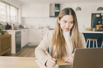 Young adult Asian woman working from home, distance learning, online teaching, video conference concept