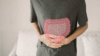 Man hands on his stomach with intesline, probiotics food for gut health, colon cancer, bowel...