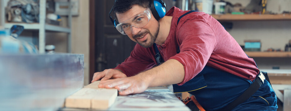 Professional carpenter working machine at shop. Banner design - Powered by Adobe