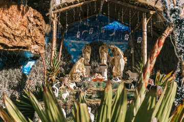 Life size decoration with statues of holy family of jesus, surrounded with animals and plants.