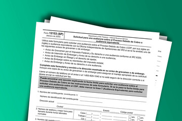 Fototapeta premium Form 12153 (SP) documentation published IRS USA 03.24.2020. American tax document on colored
