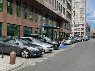 Different modern cars parked on city street