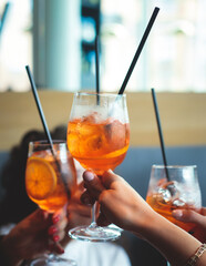 View of alcohol setting on catering banquet table, row line of orange red colored aperitif alcohol...