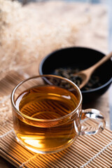 Hot tea in cup glass with dried tea leaves, Healthy drink