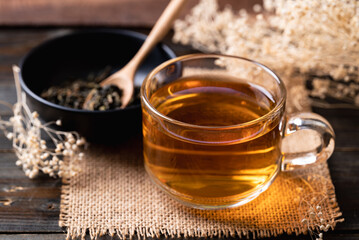 Hot tea in cup glass with dried tea leaves, Healthy drink