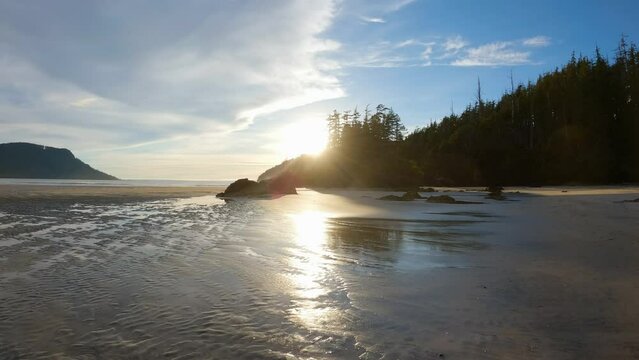 Sandy beach on Pacific Ocean Coast View. Sunset Sky. San Josef Bay, Cape Scott Provincial Park, Northern Vancouver Island, BC, Canada. Canadian Nature Background. Cinematic 4k