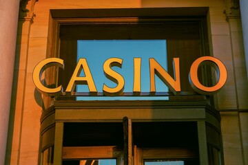 Closeup of an entrance of a casino gambling hall at sunset
