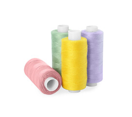 Many different colorful sewing threads on white background