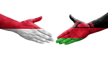 Handshake between Malawi and Monaco flags painted on hands, isolated transparent image.