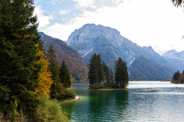 Autumn over Alpine Lake of Predil with its famous Small Island