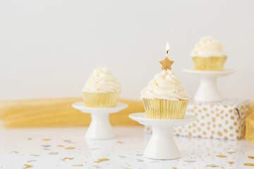 Gold Star Candle on Vanilla Cupcake