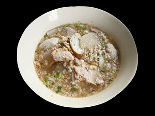 noodle chicken soup with vegetables and spices on black background