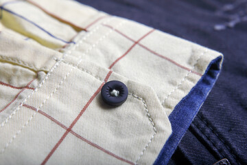 Close up view of a black button from a shirt	
