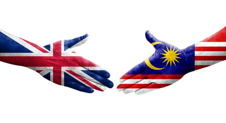 Handshake between Malaysia and United Kingdom flags painted on hands, isolated transparent image.