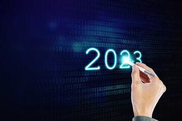 Businessman write 2023 number on virtual screen