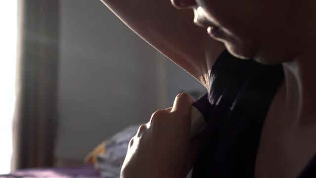 Asian woman using electric shaving armpit depilation at home process