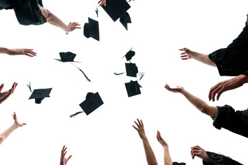 Graduating students hands throwing graduation caps on white background