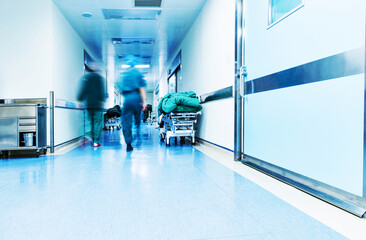 Doctors or nurses walking in hospital hallway, blurred motion