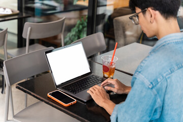 Portrait of Asian male student sitting at a coffee shop