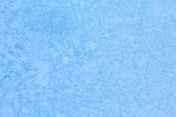 Texture of winter ice surface. Blue natural ice background