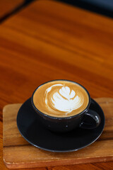 hot latte art coffee on wood table, relax time