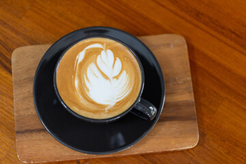 hot latte art coffee on wood table, relax time