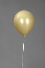 gold color balloon isolated in grey background