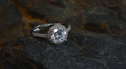 A diamond ring is a glittering wedding ring placed on the ground.