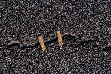 Cracked asphalt road with adhesives