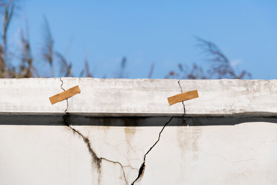 Cracked concrete parapet with adhesive