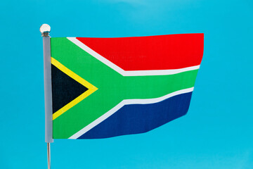 South Africa flag waving on blue background