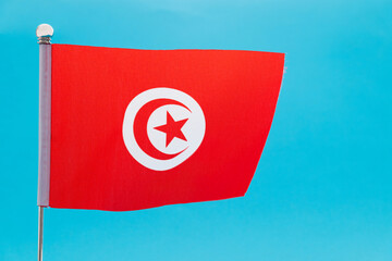 Tunisian flag waving on blue background