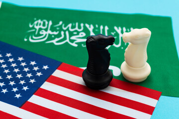 Two knights standing on American flag and Saudi Arabia flag