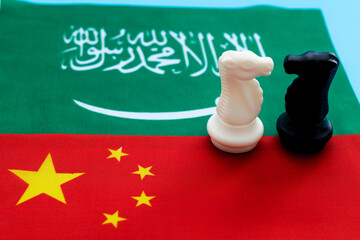 Two knights standing on Chinese flag and Saudi Arabia flag