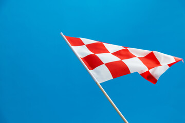 Checkered flag waving on blue background