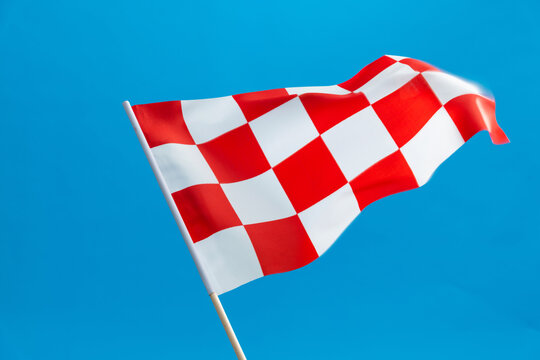 Checkered flag waving on blue background