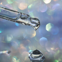 A pipette with a drop of serum in a Christmas theme .