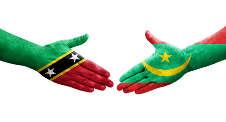 Obraz na płótnie Canvas Handshake between Mauritania and Saint Kitts and Nevis flags painted on hands, isolated transparent image.
