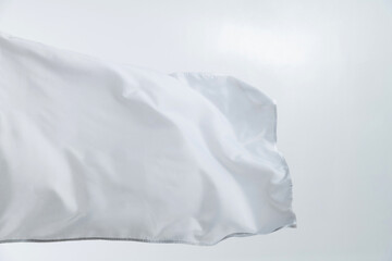 Obraz premium White flag waving on white background