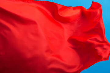 Red flag waving on blue background
