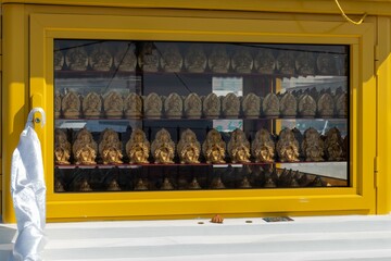 Golden figurines of the praying Buddha inside the stupa on the territory of the datsan "Rinpoche Bagsha"