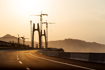 Construction of bridge under sunset